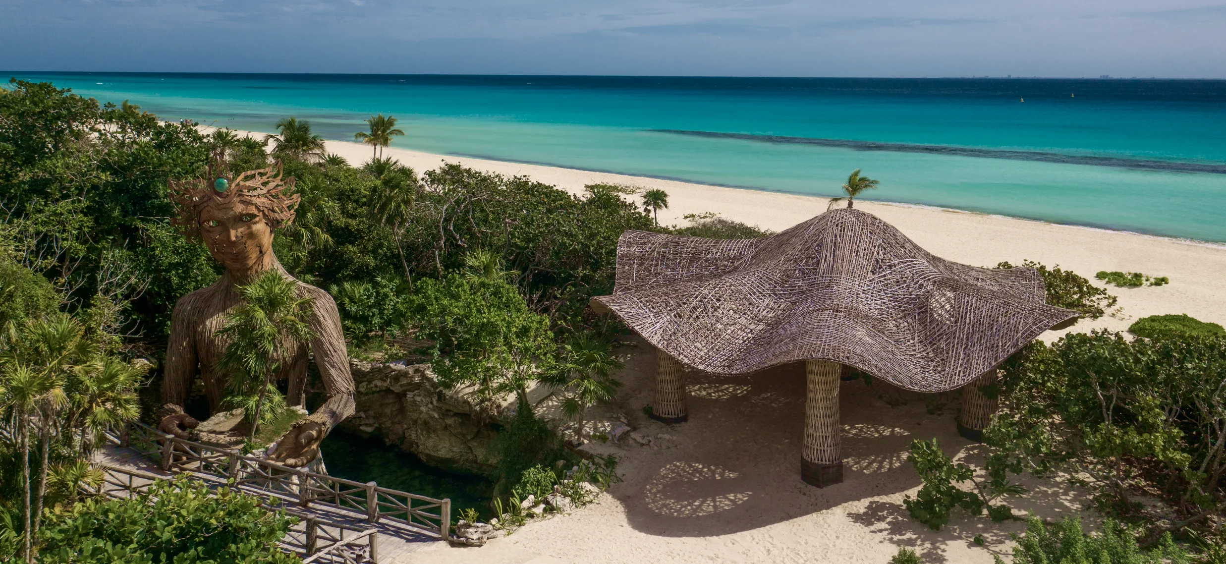 Aerial view of the Palmaïa beach, pavilion, and jungle sculpture