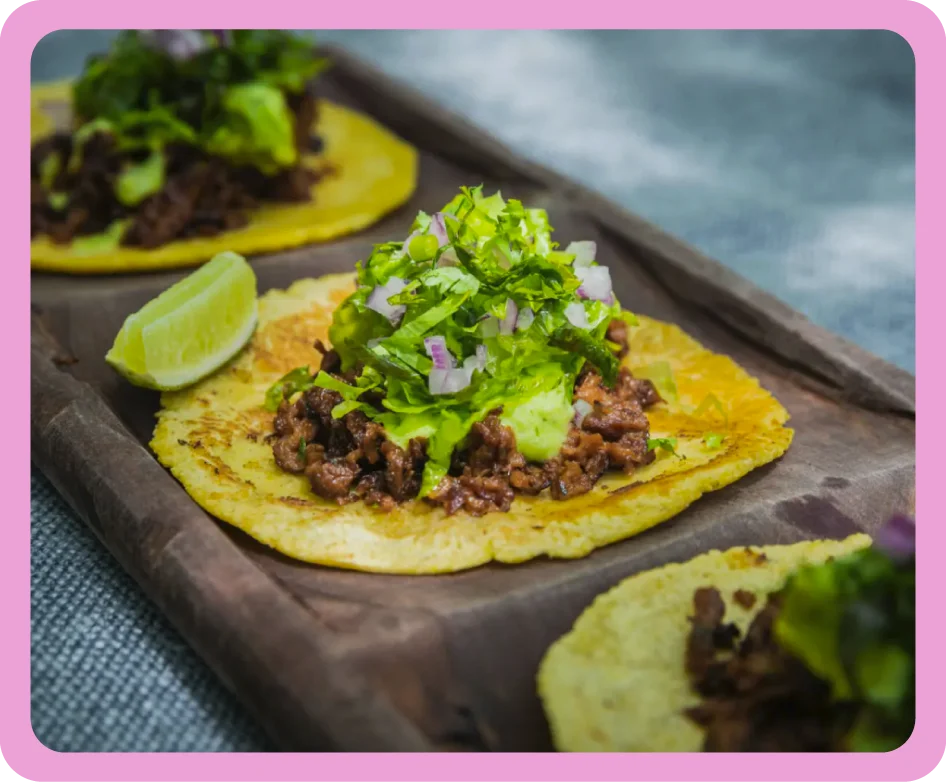 Plated tacos with fresh herbs and lime